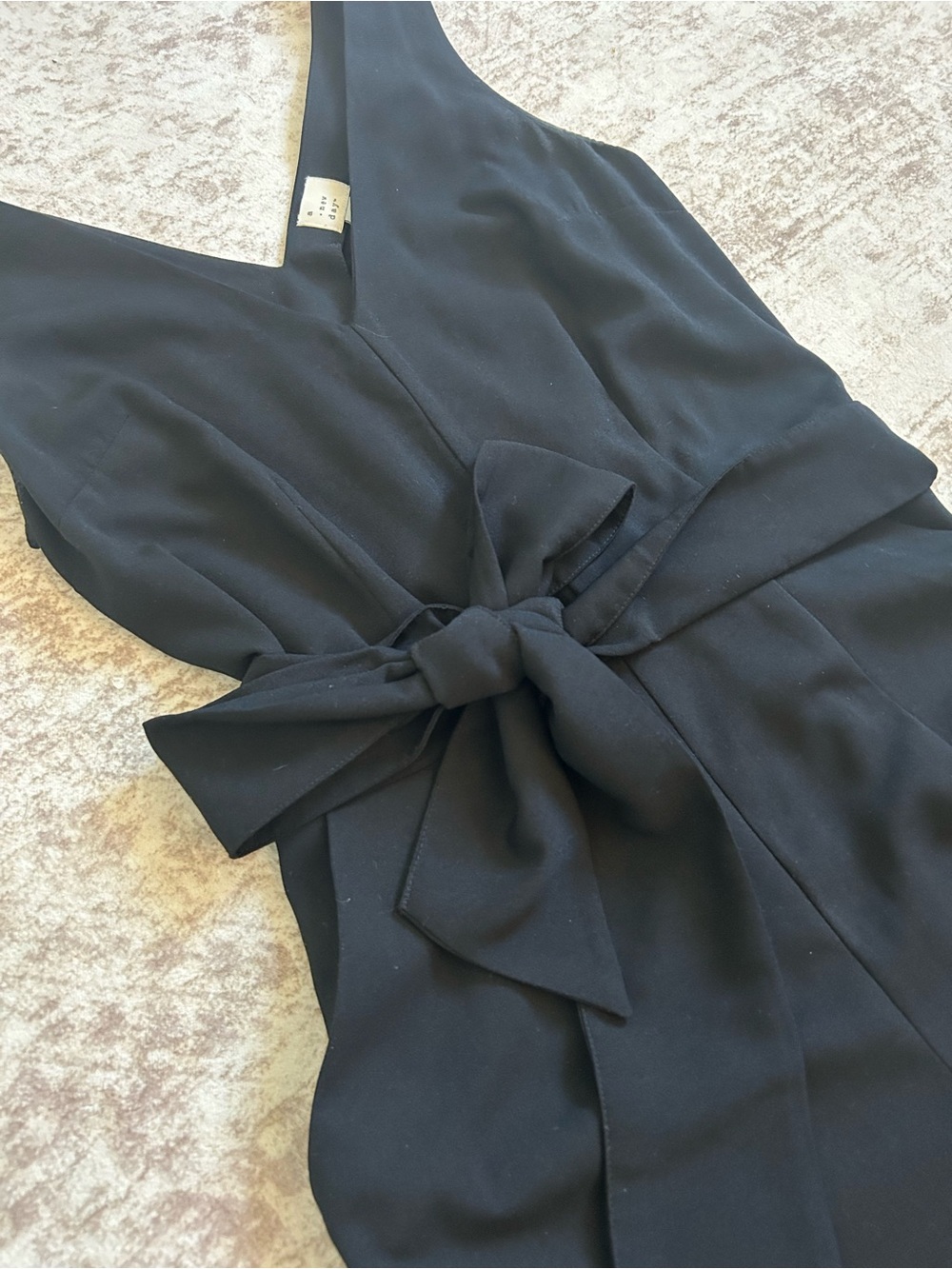 Black cropped jumpsuit with tie belt and v neck and back